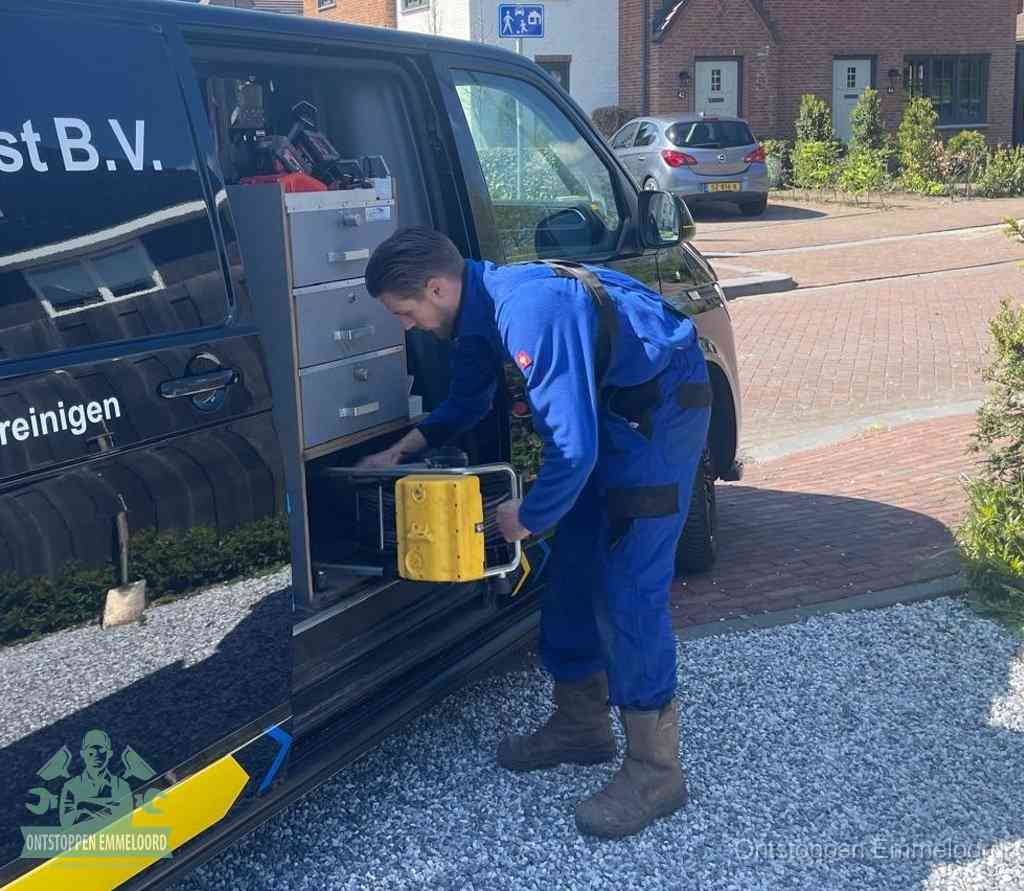 Een monteur pakt gereedschap uit de bedrijfsbus, het moment om een professionele ontstoppingsdienst in te schakelen in Emmeloord